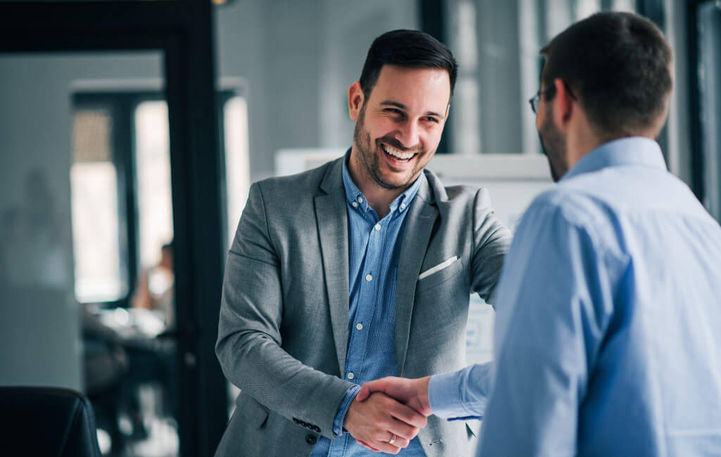 Two men shaking hands | Why is mobile advertising important?