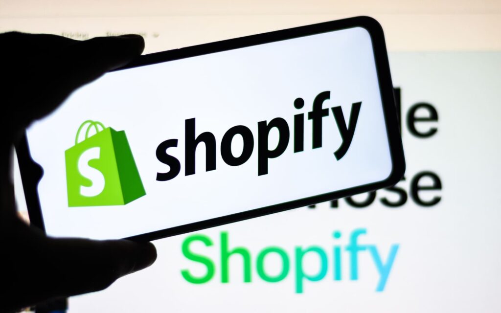 Shopify logo on phone and screen | Shopify’s North Star metric